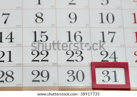 End of the month with red plastic mark frame on 31 digit calendar macro shoot