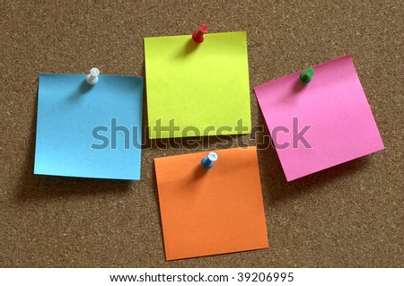 Color sticker notes over cork board background
