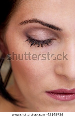 half portrait of a girl face with makeup, one eye close