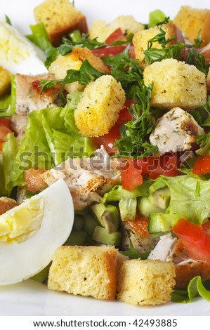 Fried chicken salad extreme closeup macro over white background