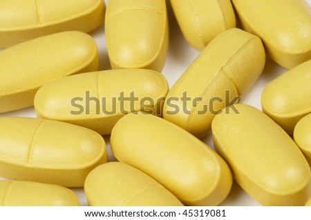 Glossy rounded multi vitamin pills macro shot background