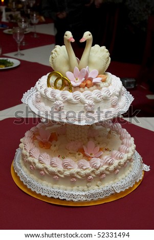 Wedding cake with two little swans on the table