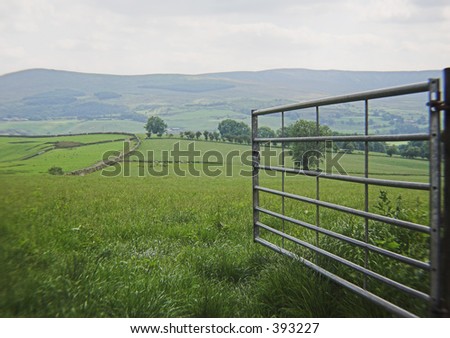 A gate stands open to beautiful rolling countryside