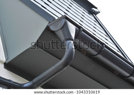 Lateral coated metal Panel, coated Rain Gutter and Rain Water Pipe at a Roof, covered with Metal Shales