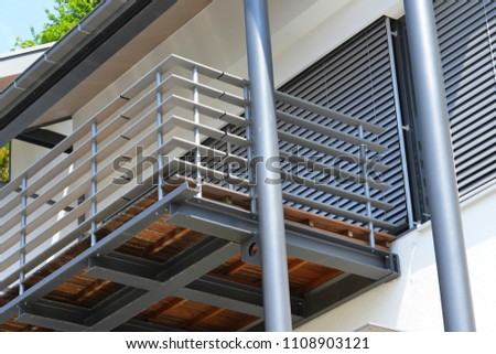 Balcony with Handrails of high-grade Steel in Front of a modern residential Building