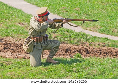 LOSHANY, BELARUS - MAY 5: a military history club member in Imperial Japanese officer uniform shoots during historical reenacting show at Stalin\'s Line memorial on May 05, 2013 in Loshany, Belarus