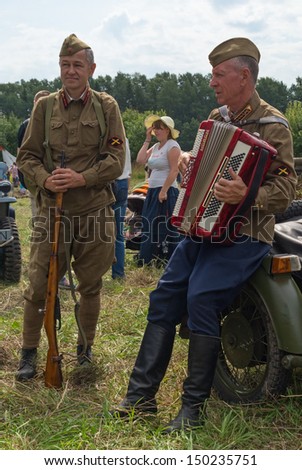 DUBOSEKOVO, RUSSIA - JULY 13: two veterans in the historic Red Army artillery uniform sing with accordion during Field of Battle military history festival on July 13, 2013 in Dubosekovo, Russia