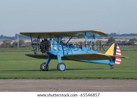 DUXFORD, UK - OCTOBER 10: Boeing Stearman vintage biplane is displayed on the flight lane during Autumn Air Show on October 10, 2010 in Duxford, UK