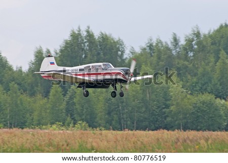 TVER, RUSSIA - JULY 09: Yak-18t trainer plane lands during the Tver Blue Skies aviation festival on July 09, 2011 in Tver, Russia