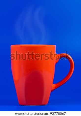 Mug with steam on blue background.