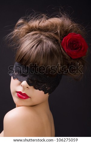 Mysterious woman wearing black lace mask