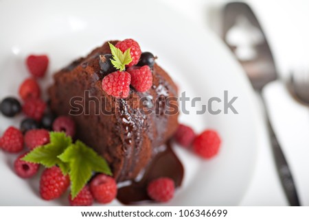 Tasty chocolate biscuit with fresh fruits and chocolate glaze