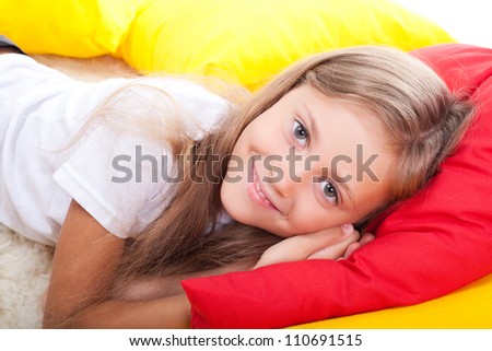 Girl lying on color pillows