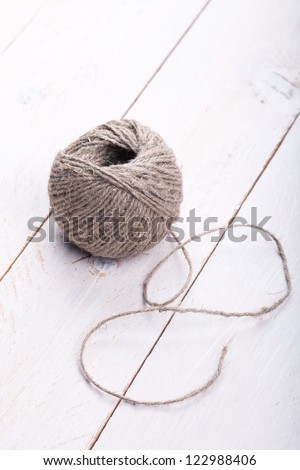 Skein of jute twine on the white wooden background