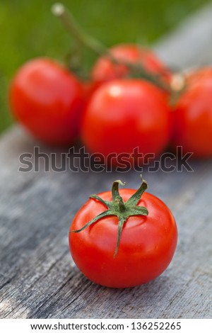 Fresh sweet tomato on the wooden table