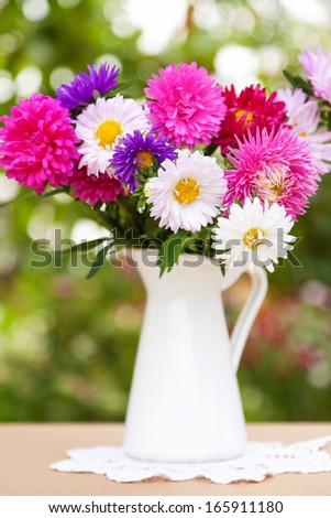 Asters flowers bouquet in vase outdoor
