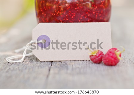Blank Paper label outdoor with fresh raspberries fruits