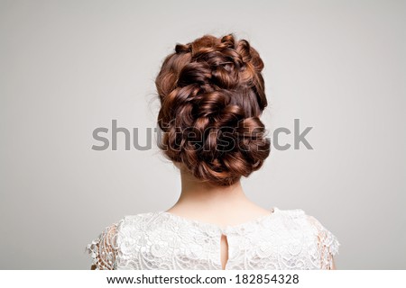 hairstyle portrait of beautiful brunette girl with creative braid hairdo in white dress