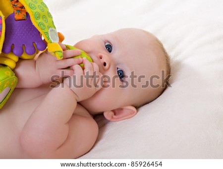 Little baby girl with teething toy