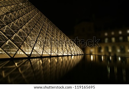 PARIS - MAY 8: Louvre Pyramid at dusk on May 8, 2012 in Paris, France. The Louvre is the biggest Museum in Paris