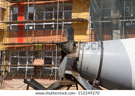 Cement trucks on the background of construction
