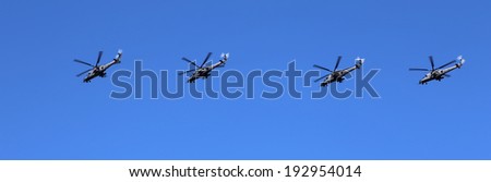 MOSCOW, RUSSIA- MAY 09, 2014: Russian military helicopters fly in formation over Red Square during Victory Day parade, Moscow, Russia.