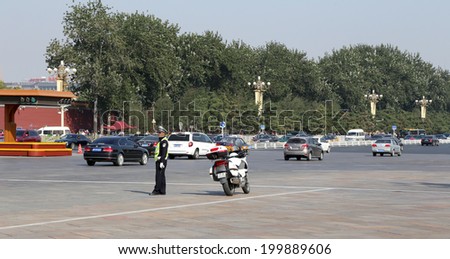 BEIJING, CHINA OCTOBER 11, 2013: police officer with bike on the road in central Beijing, China