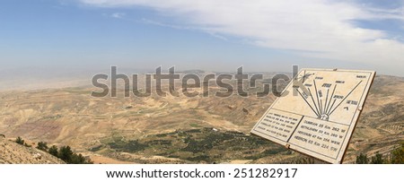 desert mountain landscape (aerial view from Mount Nebo) and plaque showing the distance from Mount Nebo to various locations, Jordan, Middle East