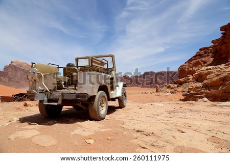 WADI RUM DESERT, JORDAN- APRIL 10, 2014: Car in the Wadi Rum Desert -- also known as The Valley of the Moon is a valley cut into the sandstone and granite rock in southern Jordan
