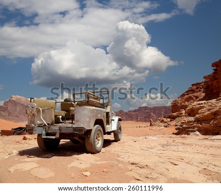 WADI RUM DESERT, JORDAN- APRIL 10, 2014: Car in the Wadi Rum Desert -- also known as The Valley of the Moon is a valley cut into the sandstone and granite rock in southern Jordan