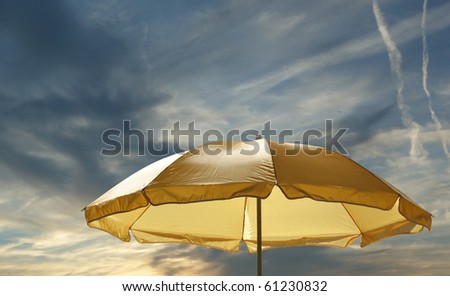 Beach umbrella (sunshade) against the clear summer sky