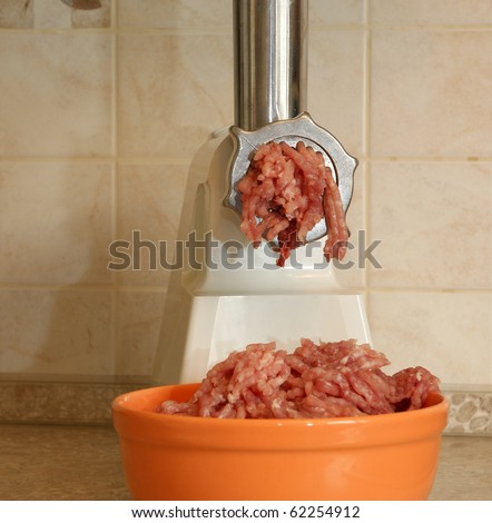 Meat grinder in action. Raw beef