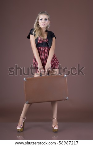 The girl with a suitcase in hands, focus on eyes