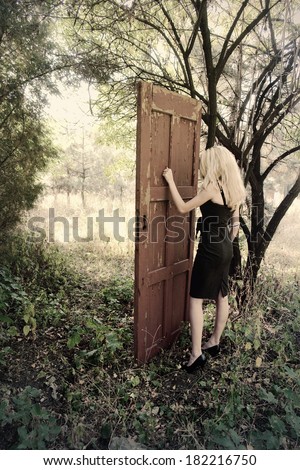 Mystical place. Girl in front of the magic door in the forest