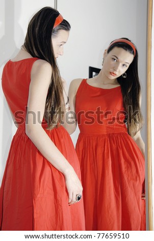 Girl standing at mirror