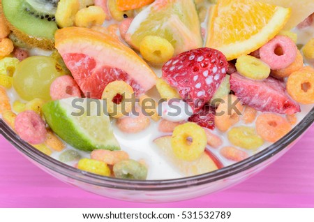 cereal with fruit in bowl on pink wooden table
