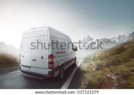 Delivery truck drives on a mountain road