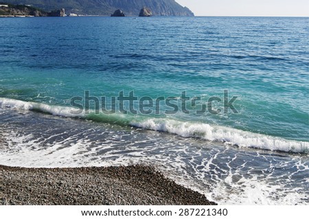 Surf, view of foot of Bear mountain( Ayu-Dag) and rocks-twins Adalari, Gurzuf, Crimea.
