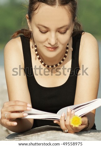 The beautiful girl reads the book
