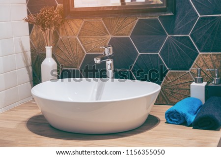 Interior of bathroom with sink basin faucet and mirror. Modern design of bathroom.