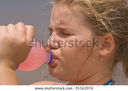Young girl drinking lemonade on a hot summer day