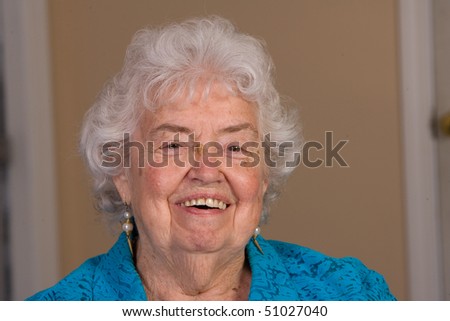 Happy senior citizen woman laughing in this closeup.