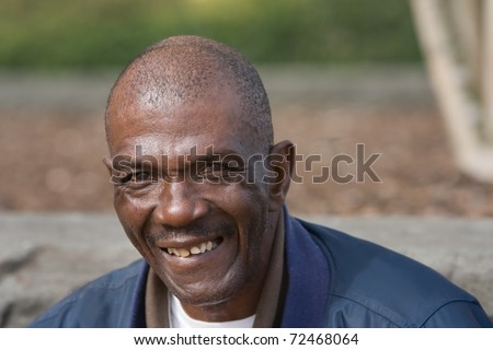 Smiling old African American man outside during the daytime