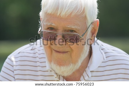 Old man wearing glasses outside during the day