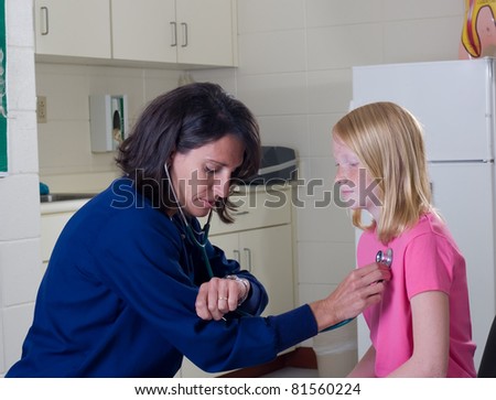 School nurse with stethoscope checking pulse of female patient.