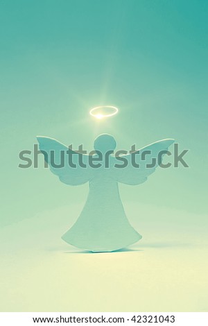 Angel cut out from a cardboard with a shone nimbus