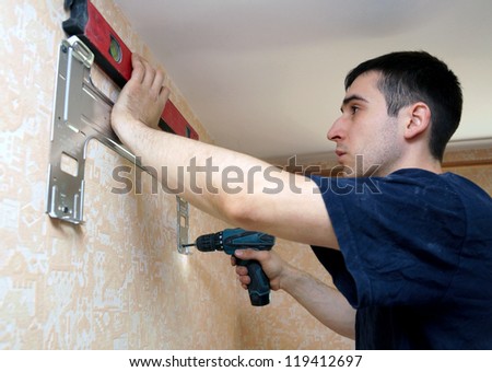 real photo of installation of the conditioner, fastening to a wall