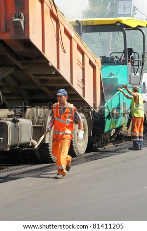 MOSCOW - JUNE 22: Brigade of workers repairs road under the program of planned repair in  Marino on June 22, In the government of Moscow have planned to repair in 2011 24,6 million in sq.m. of roads