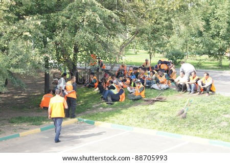MOSCOW - AUGUST 30: Guest workers have a rest in a shade of trees on \