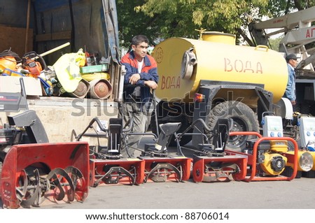 MOSCOW - AUGUST 30: guest worker near to manual snow-plows on \